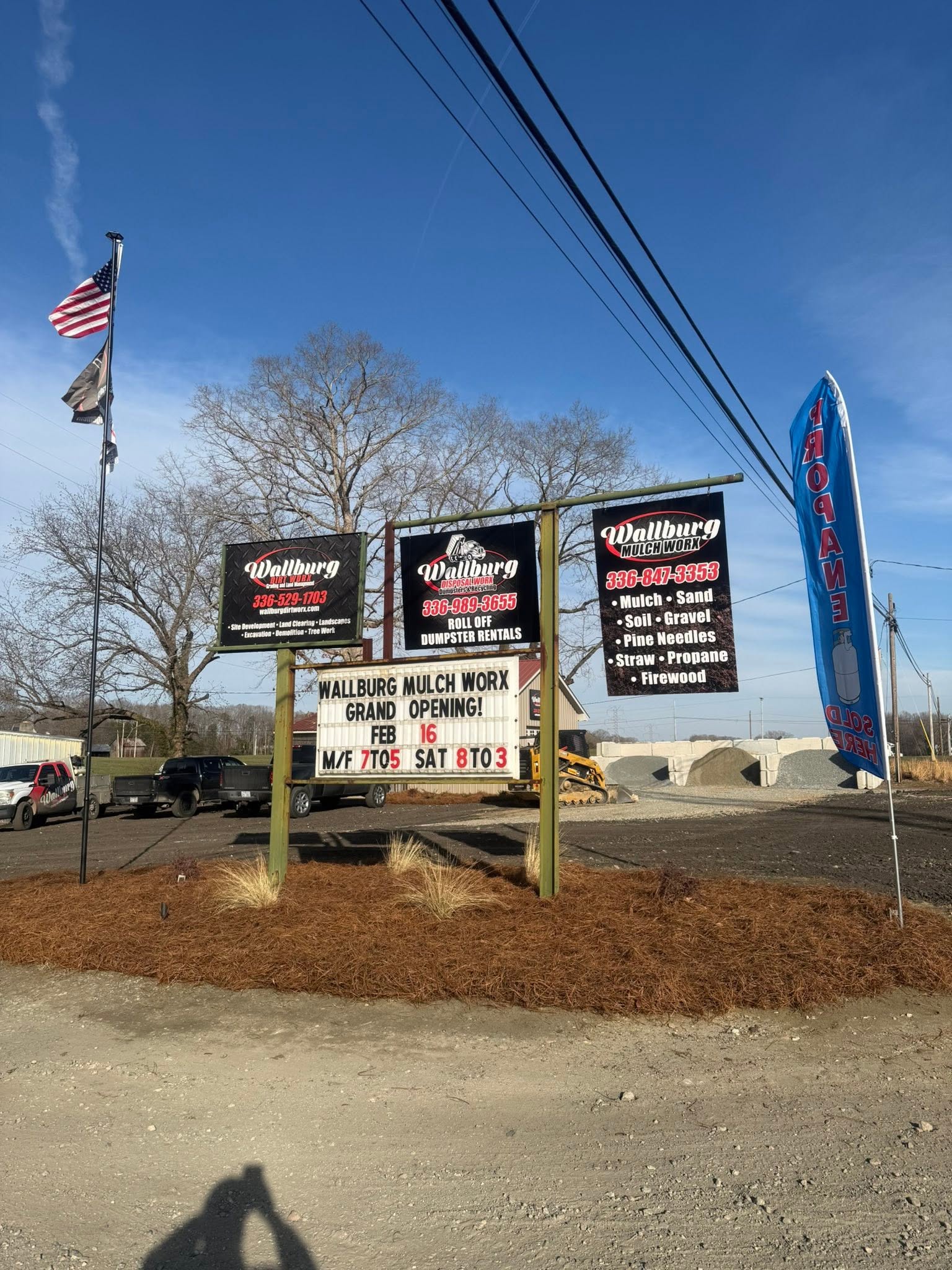 Wallburg Mulch Worx road sign showing the opening hours at the yard entrance in High Point NC